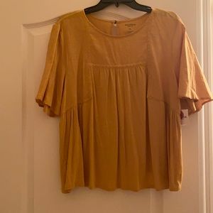 A Yellowish gold, longer short-sleeved cute kids Top